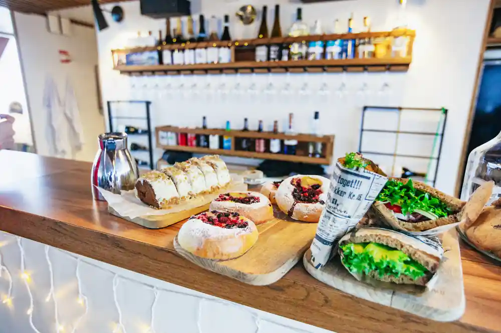 Cafe counter with baked goods and sandwiches displayed