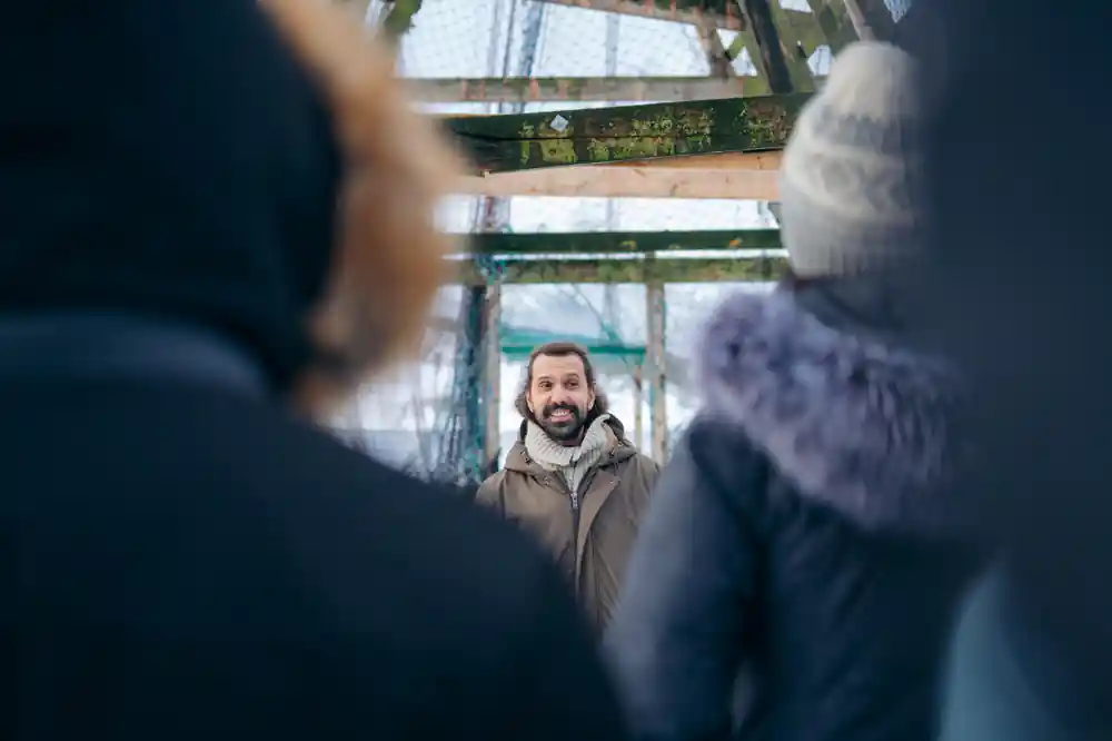 Man standing on bridge viewed through narrow opening