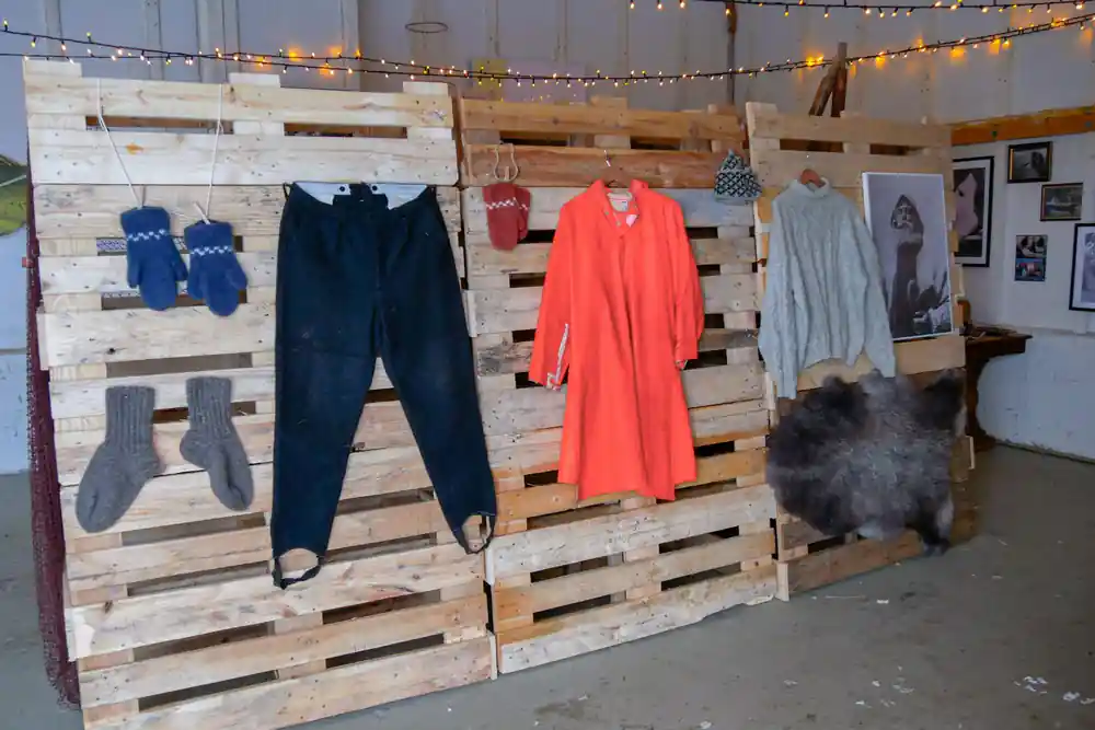 Wooden pallet display with clothing and fur items hung
